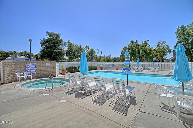 view of pool featuring a community hot tub and a patio