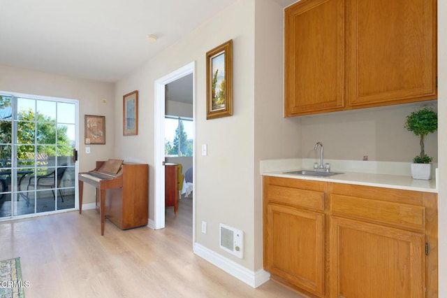 kitchen with sink and light hardwood / wood-style floors