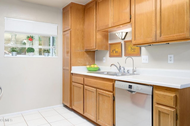 kitchen with dishwasher, light tile patterned floors, and sink