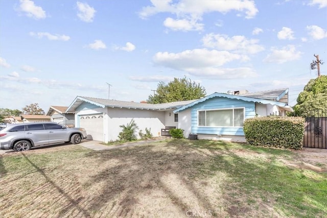 ranch-style house featuring a garage and a front yard