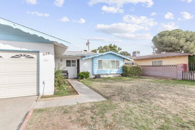 ranch-style home with a front yard and a garage