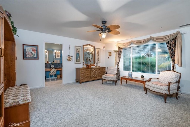 living area featuring carpet flooring and ceiling fan