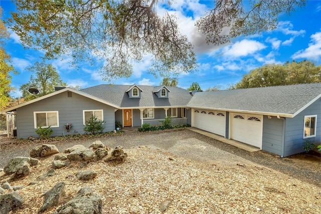 view of front of house featuring a porch and a garage