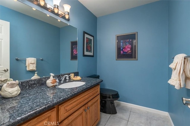 bathroom featuring tile patterned flooring, vanity, and toilet