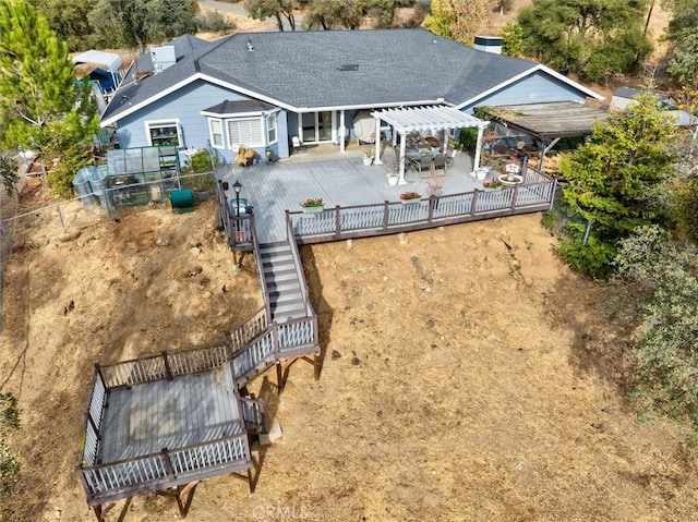 rear view of property featuring a pergola