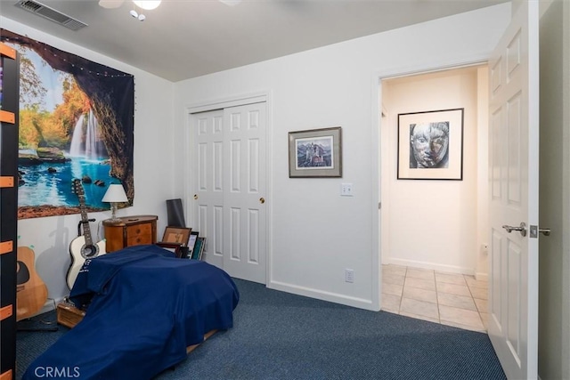 carpeted bedroom featuring ceiling fan and a closet