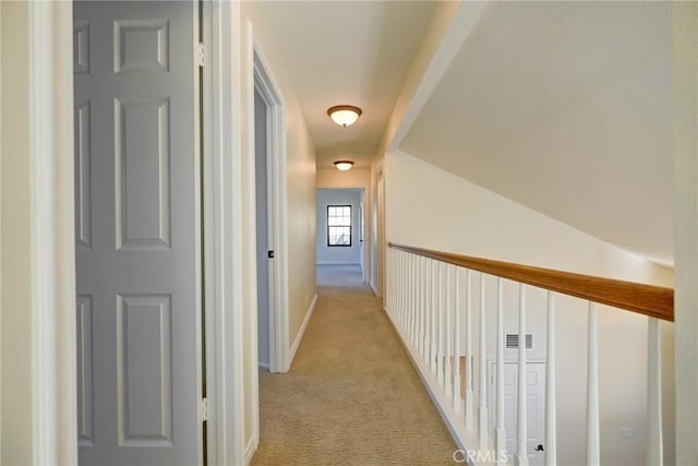 hallway with light colored carpet