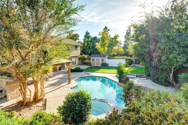 view of swimming pool with a lawn, a storage shed, and a patio