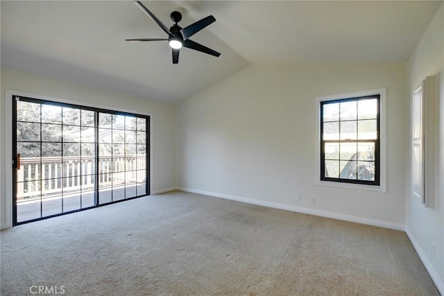 carpeted empty room featuring ceiling fan and lofted ceiling