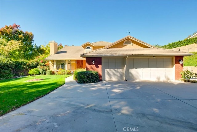 view of front of home featuring a garage and a front yard