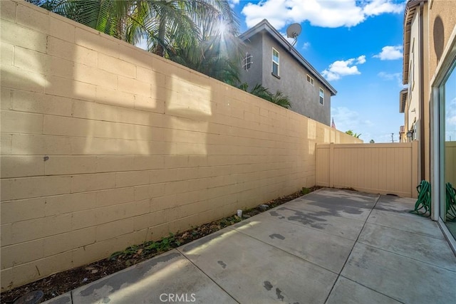 view of property exterior with a patio area