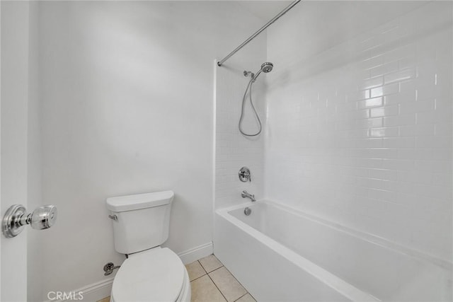 bathroom featuring tile patterned floors, tiled shower / bath combo, and toilet