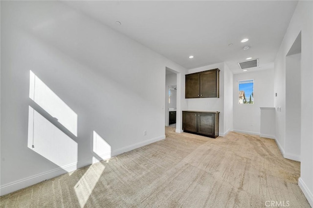 unfurnished living room featuring light colored carpet