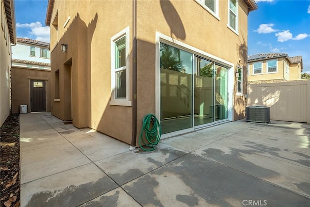 view of side of property featuring a patio area and central AC unit