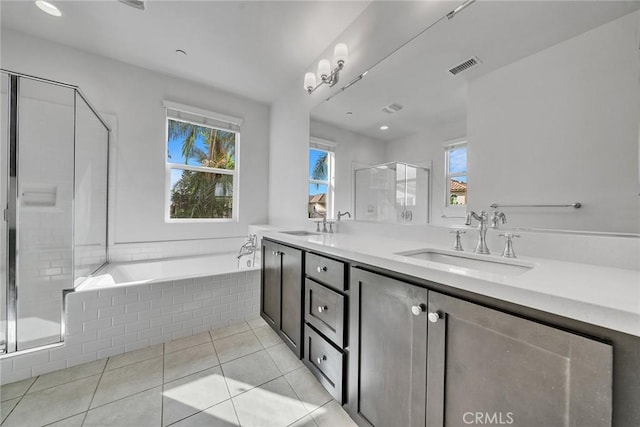 bathroom featuring tile patterned flooring, vanity, plus walk in shower, and a wealth of natural light