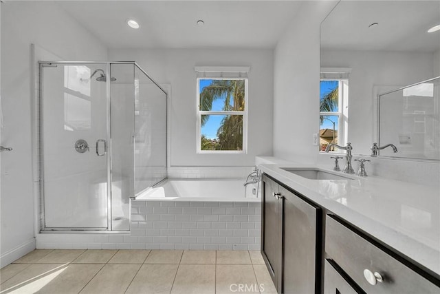 bathroom with tile patterned flooring, vanity, and separate shower and tub