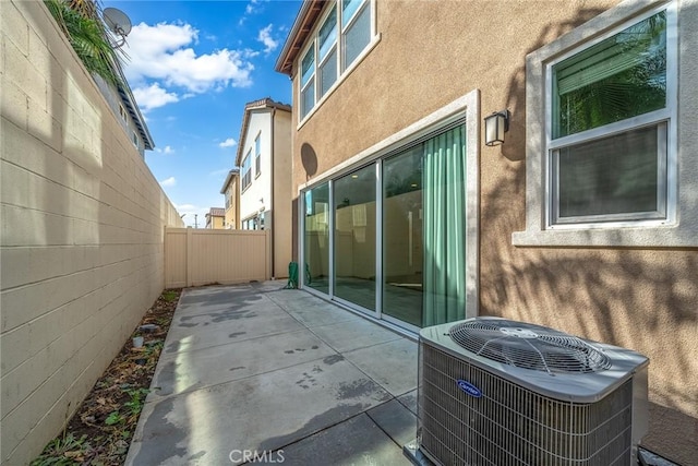 view of home's exterior with central air condition unit and a patio area