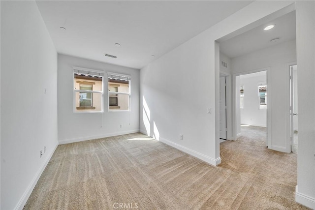 empty room featuring light colored carpet