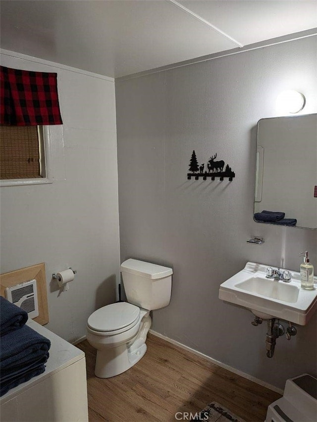 bathroom featuring hardwood / wood-style flooring, toilet, and sink