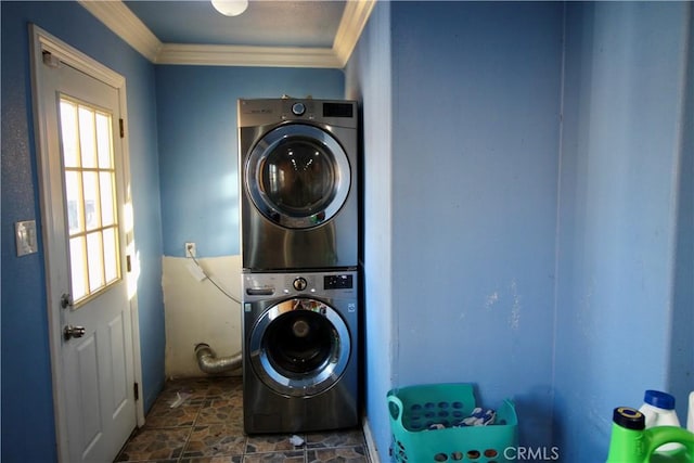 clothes washing area with crown molding and stacked washing maching and dryer