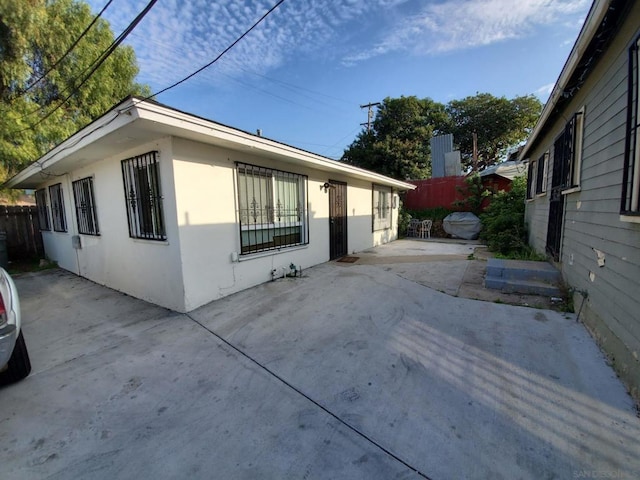 view of side of property featuring a patio area