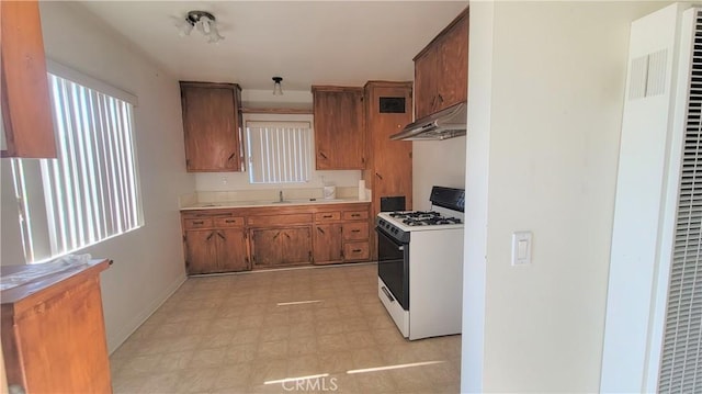 kitchen featuring sink and white range with gas cooktop