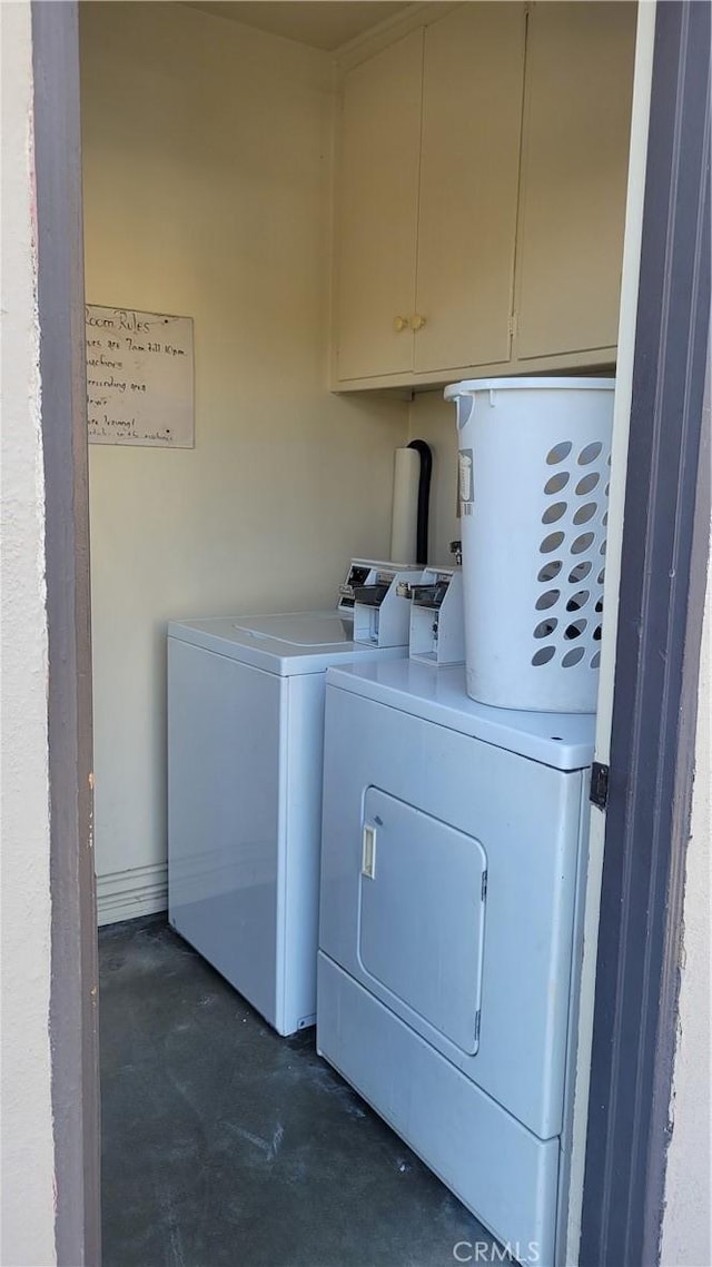 washroom featuring cabinets and independent washer and dryer