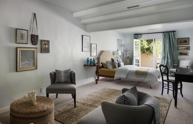 bedroom featuring beamed ceiling and light colored carpet