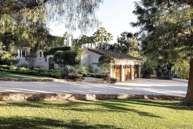 exterior space with a garage and a front yard