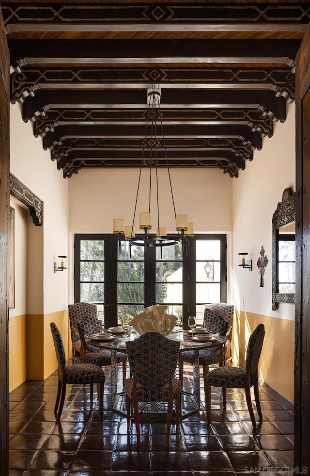 dining room with a notable chandelier, a wealth of natural light, and french doors