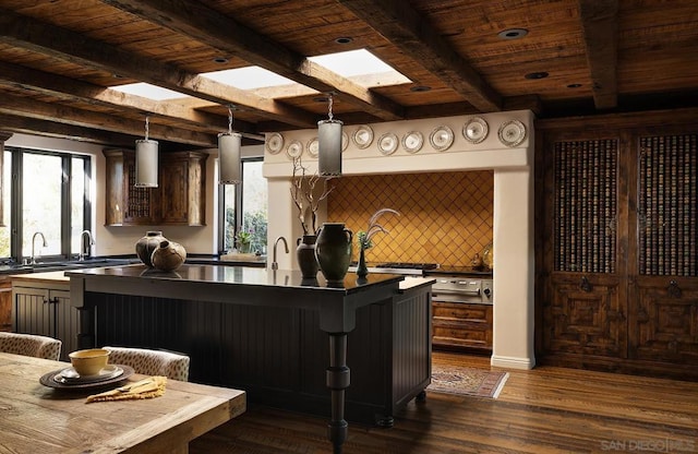 kitchen with wooden ceiling, dark hardwood / wood-style flooring, backsplash, decorative light fixtures, and a kitchen bar