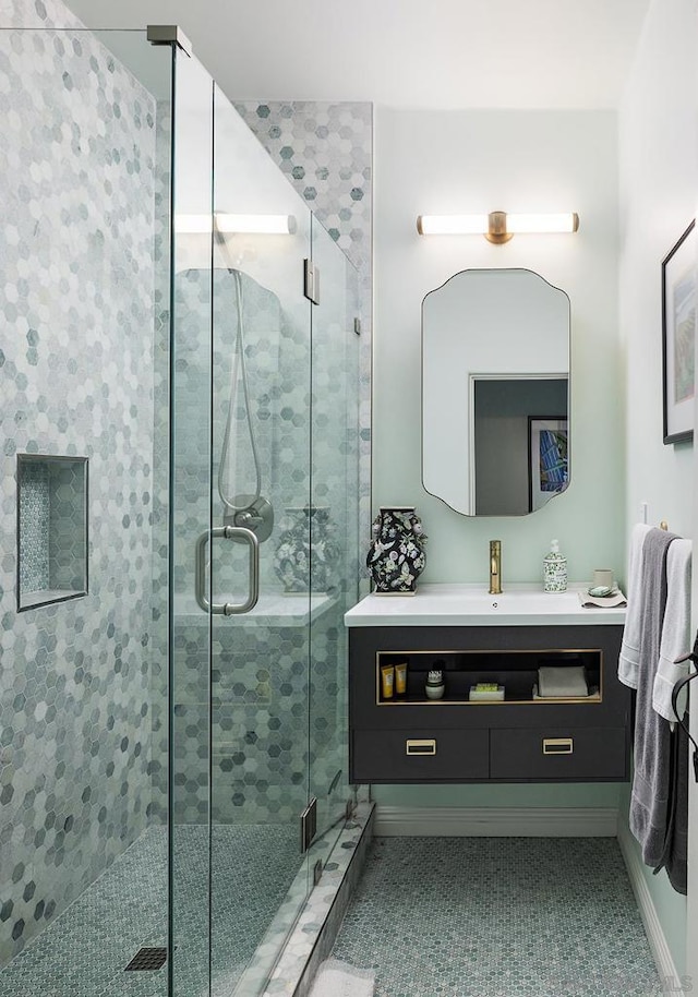 bathroom featuring tile patterned floors, vanity, and walk in shower