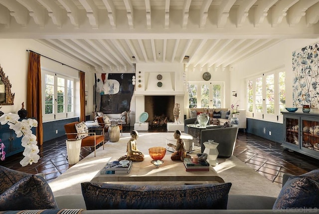 living room with french doors, a large fireplace, plenty of natural light, and beam ceiling