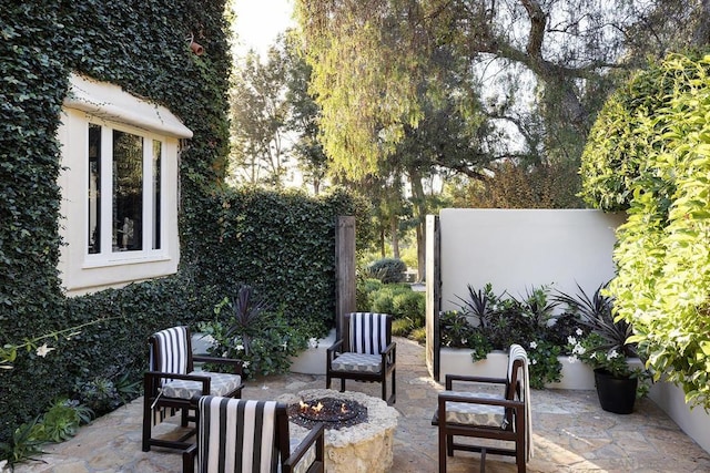 view of patio with a fire pit