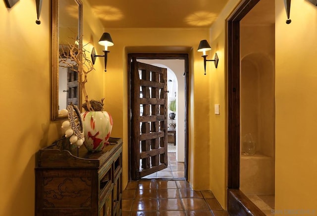 doorway with dark tile patterned flooring