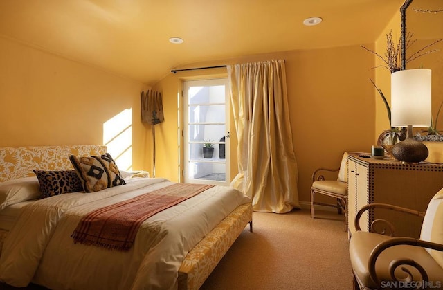 bedroom with lofted ceiling and carpet floors