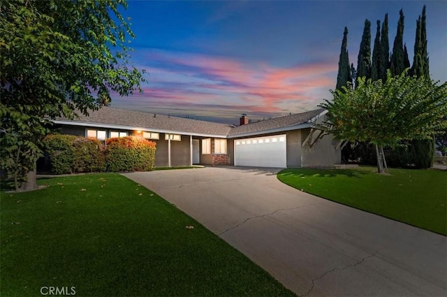 view of front of house with a lawn and a garage