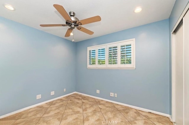 tiled empty room with ceiling fan