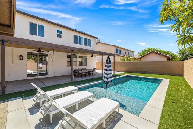 view of swimming pool featuring ceiling fan and a patio area