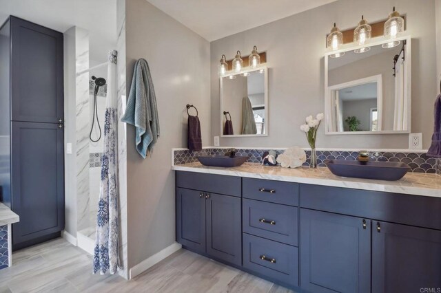 bathroom featuring vanity, a shower, and tasteful backsplash