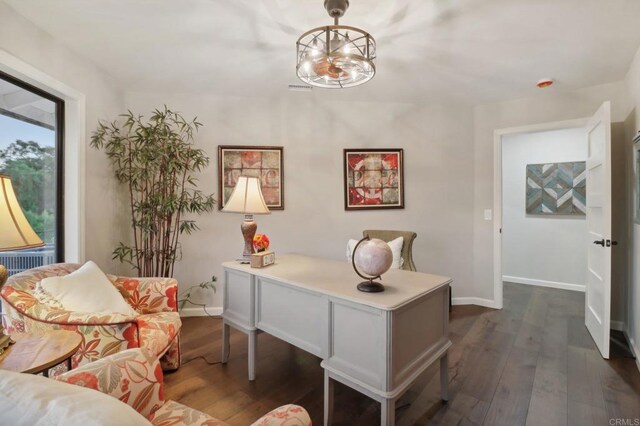 office space with dark hardwood / wood-style floors and a notable chandelier