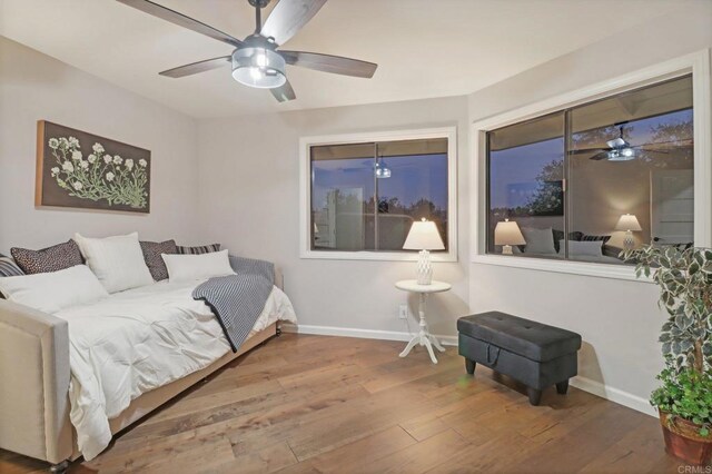 bedroom with hardwood / wood-style floors and ceiling fan