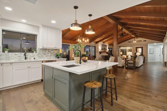 kitchen with hardwood / wood-style flooring, white cabinetry, ceiling fan, and sink