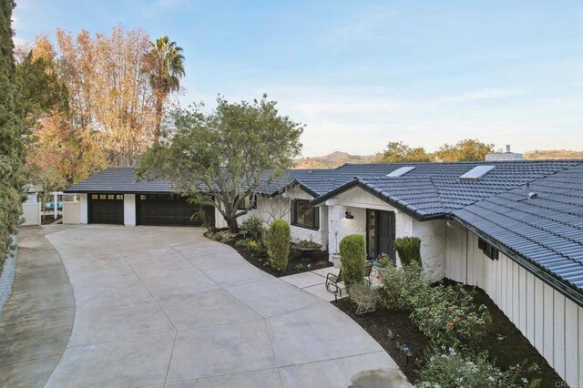 view of front facade featuring a mountain view and a garage