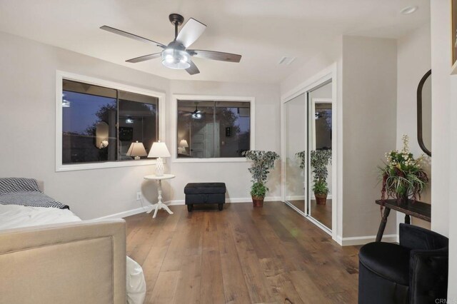 sitting room featuring dark hardwood / wood-style flooring and ceiling fan