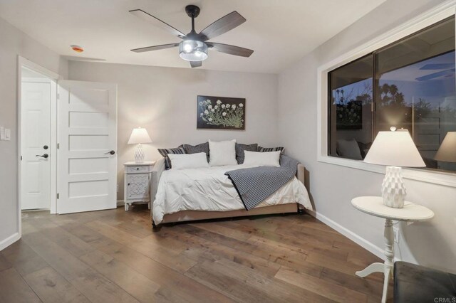 bedroom with ceiling fan and dark hardwood / wood-style floors