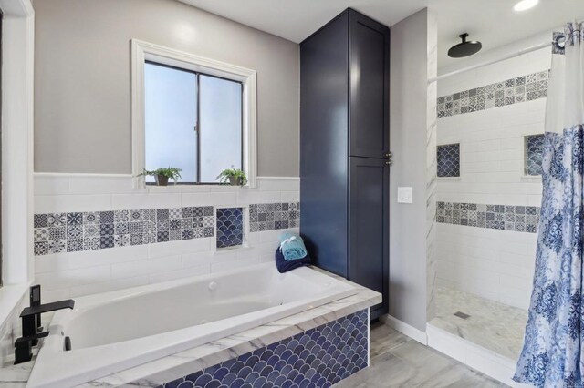 bathroom with separate shower and tub