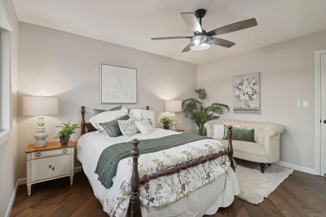 bedroom with dark hardwood / wood-style flooring and ceiling fan