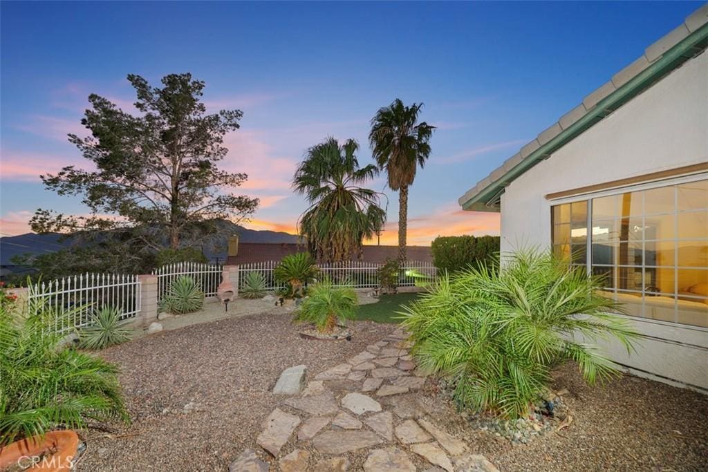 view of yard at dusk