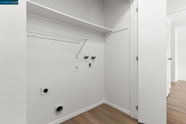 laundry area with hookup for a gas dryer, hardwood / wood-style floors, washer hookup, and hookup for an electric dryer